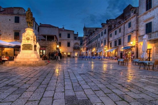 Restaurants lining Dubrovnik Stradum at dusk