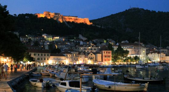 Hvar Town at dusk with the imposing fortress in the background