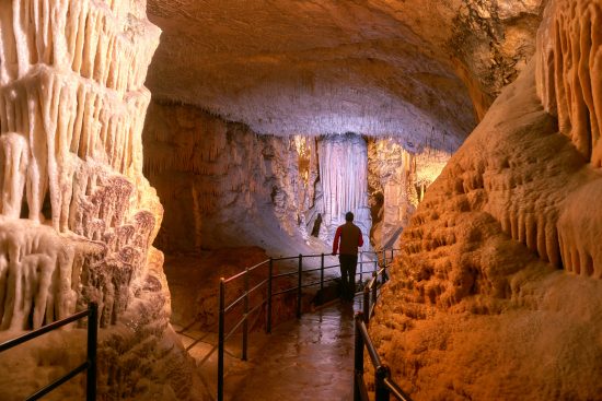 Walk through the underground world of Postojna cave.